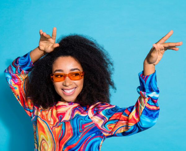 Photo portrait of attractive young woman sunglass have fun dancing dressed stylish colorful clothes isolated on blue color background